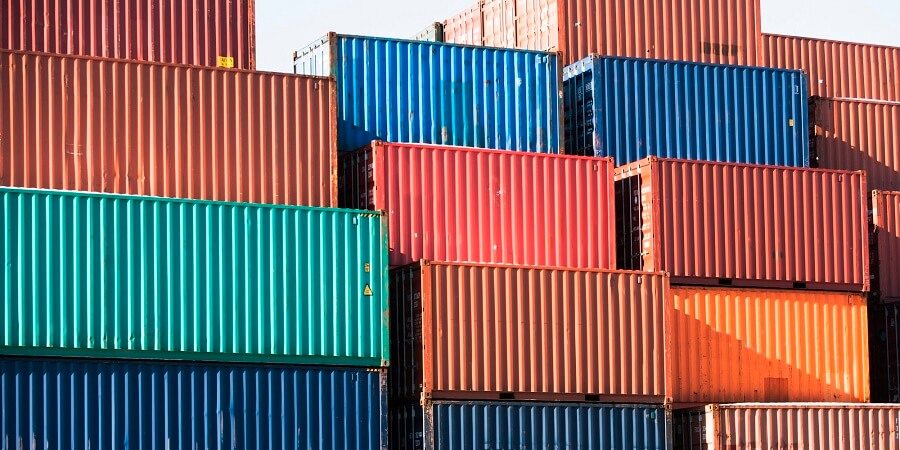 stack of colorful storage containers in shipping yard