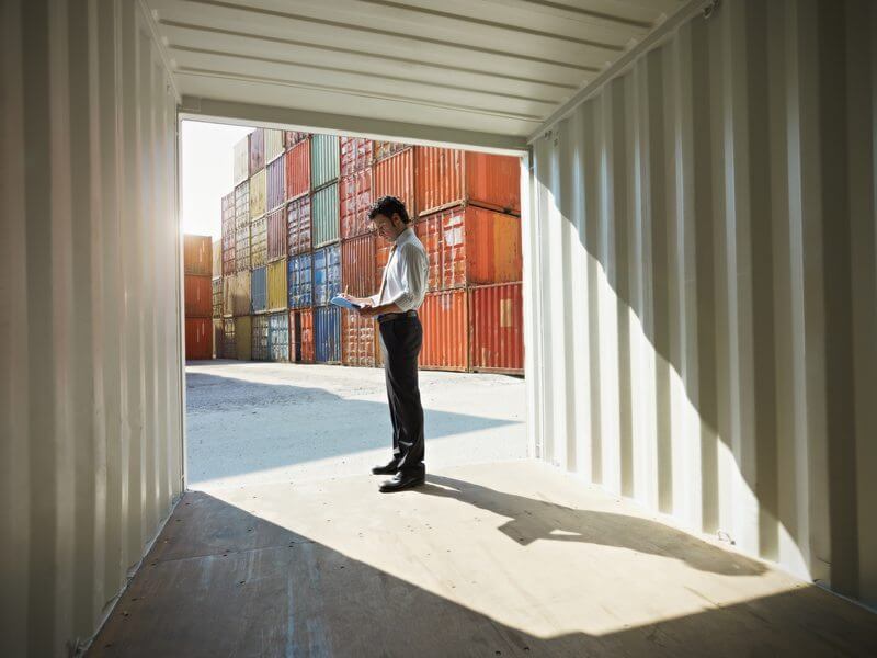 Shipping container being inspected before delivery