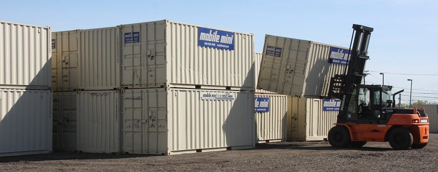 Mobile Mini storage containers, 40-footers, stacked by forklift