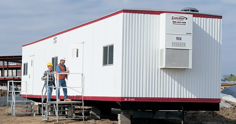 mobile office installed on concrete foundation pads at construction site