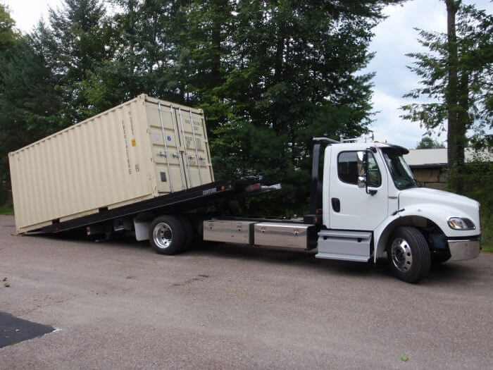 Storage container being delivered on-site Storage container being delivered on-site